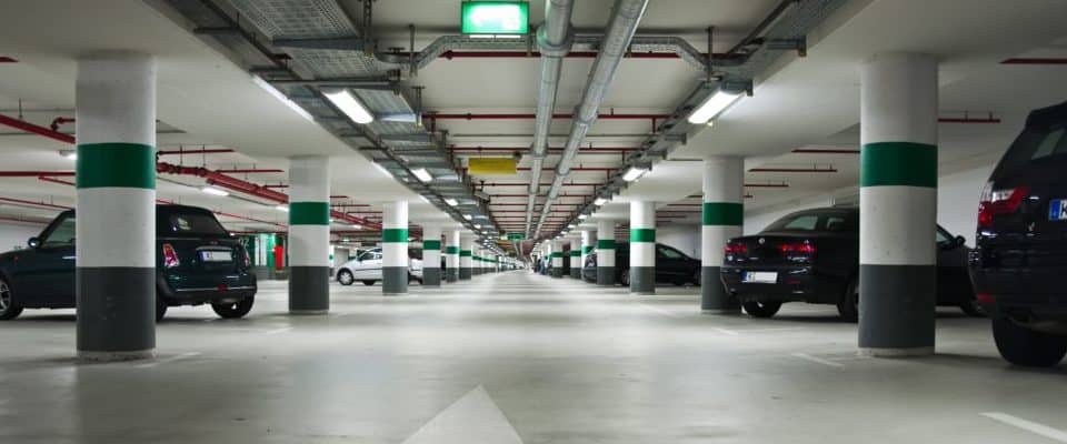 Long car park with several cars parked diagonally