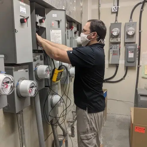 Electrician testing electrical meters and service panels by TCA Electric
