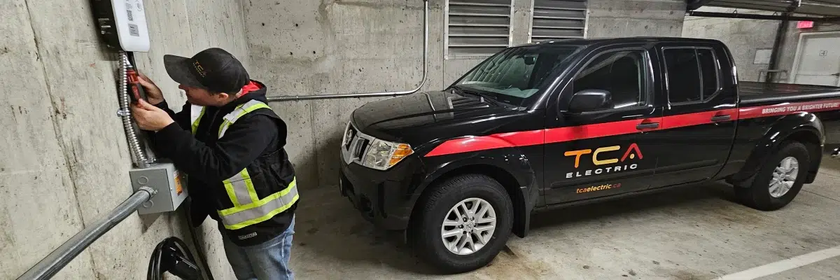 Certified electrician installing an electric vehicle charger in a parking garage by TCA Electric