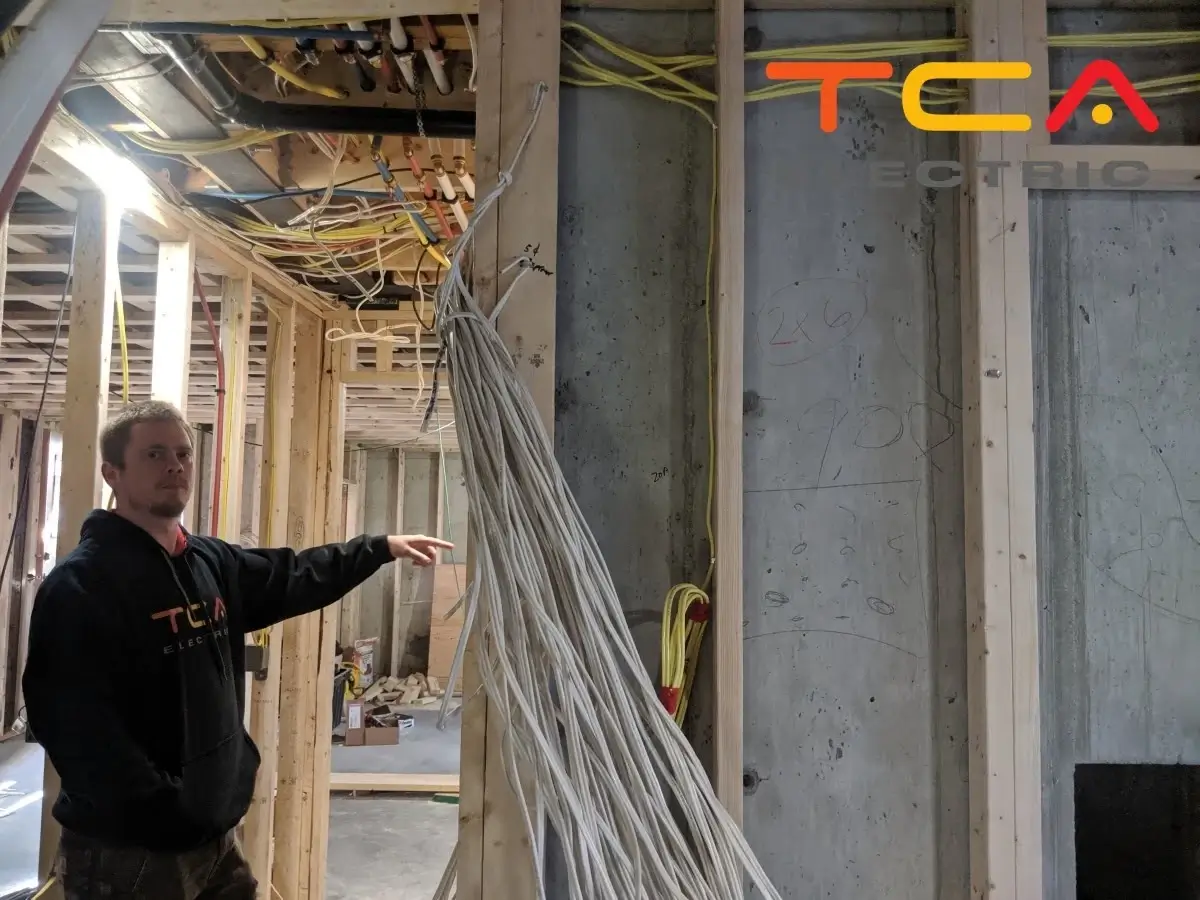 Electrician reviewing home wiring layout during new construction by TCA Electric
