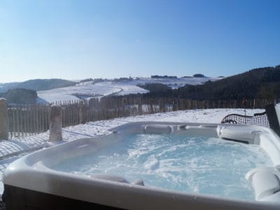 A hot tub with safe outdoor wiring on a snowy day