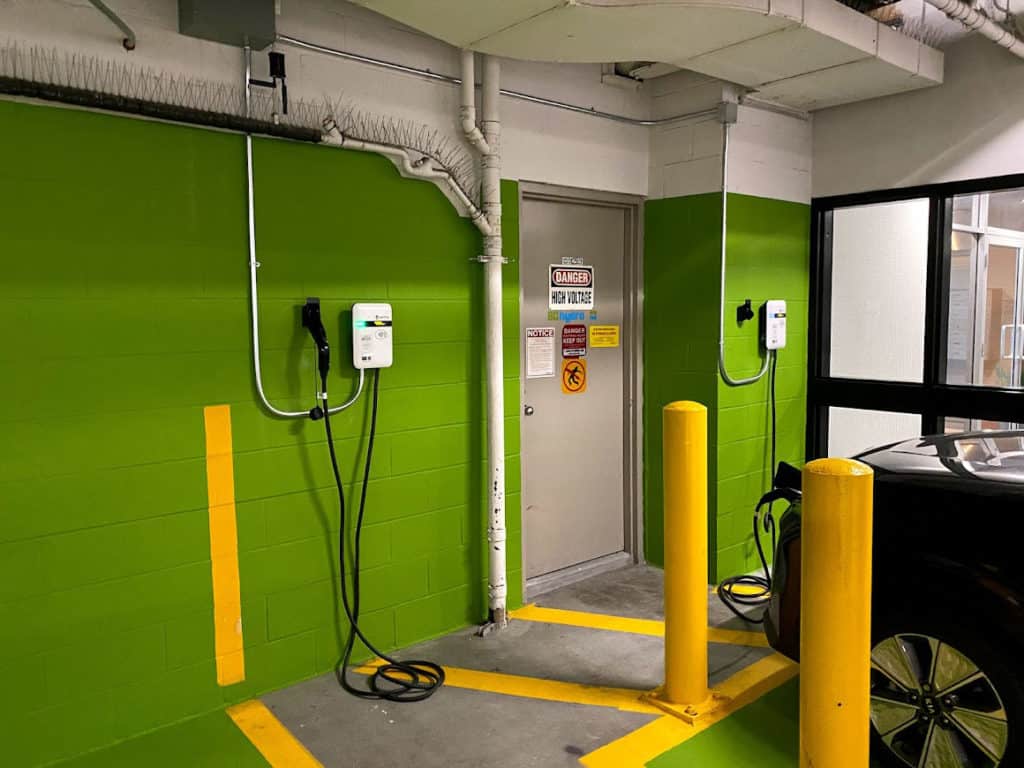 Green painted CMU wall with electrical vehicle chargers mounted