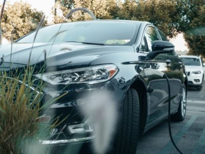 a Tesla plugged into a charger following install by an electrician