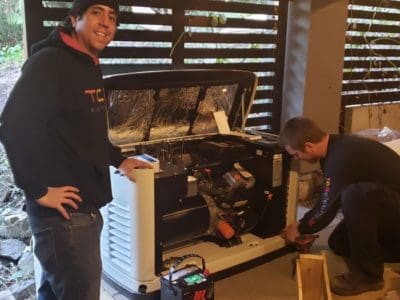 two TCA electricians completing a generator installation