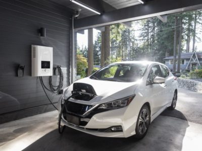 a white electric car charging in a garage near Vancouver, BC