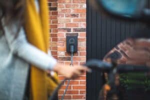 a BC homeowner plugging in their electric car to charge