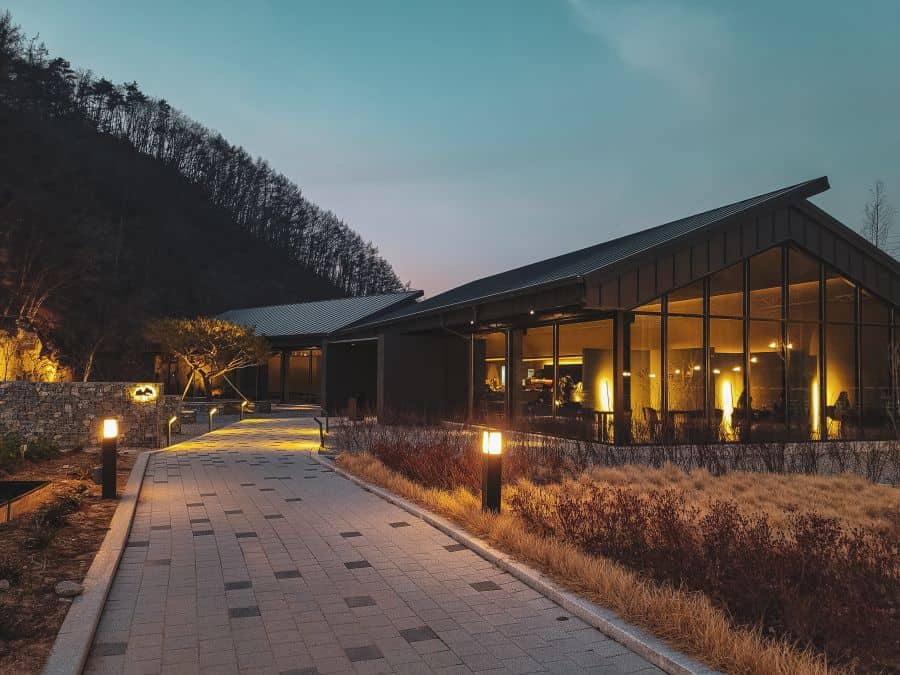 a home at night with lights on powered by a backup generator