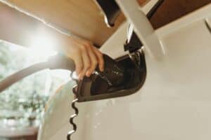 a home EV charger plugged into an electric vehicle