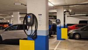 A group of electric vehicles parked beside EV Chargers made by electricians in Vancouver