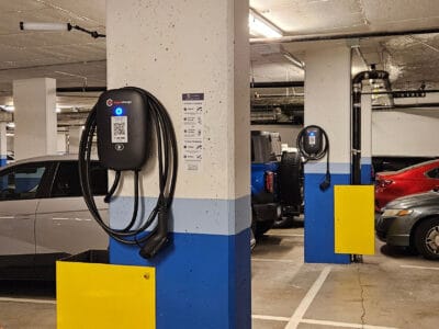 A group of electric vehicles parked beside EV Chargers made by electricians in Vancouver