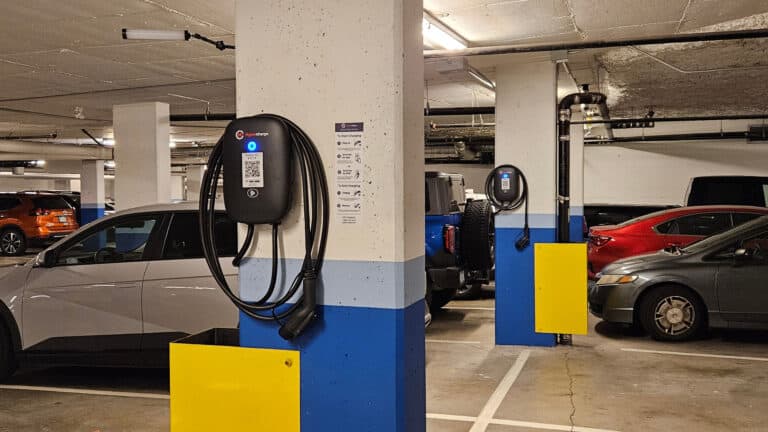 A group of electric vehicles parked beside EV Chargers made by electricians in Vancouver