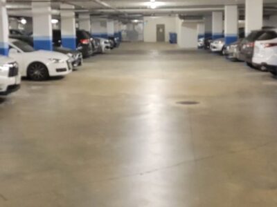 A concrete parking garage with cars parked in stalls in Vancouver