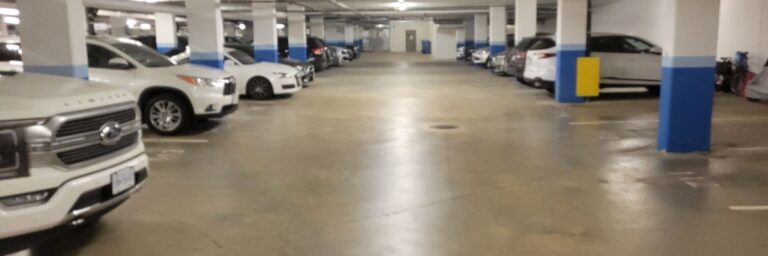 A concrete parking garage with cars parked in stalls in Vancouver