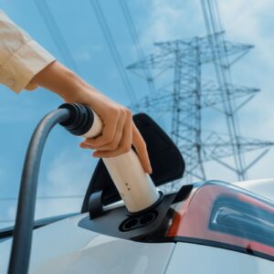 Person plugging an electric car into a charging station in Vancouver