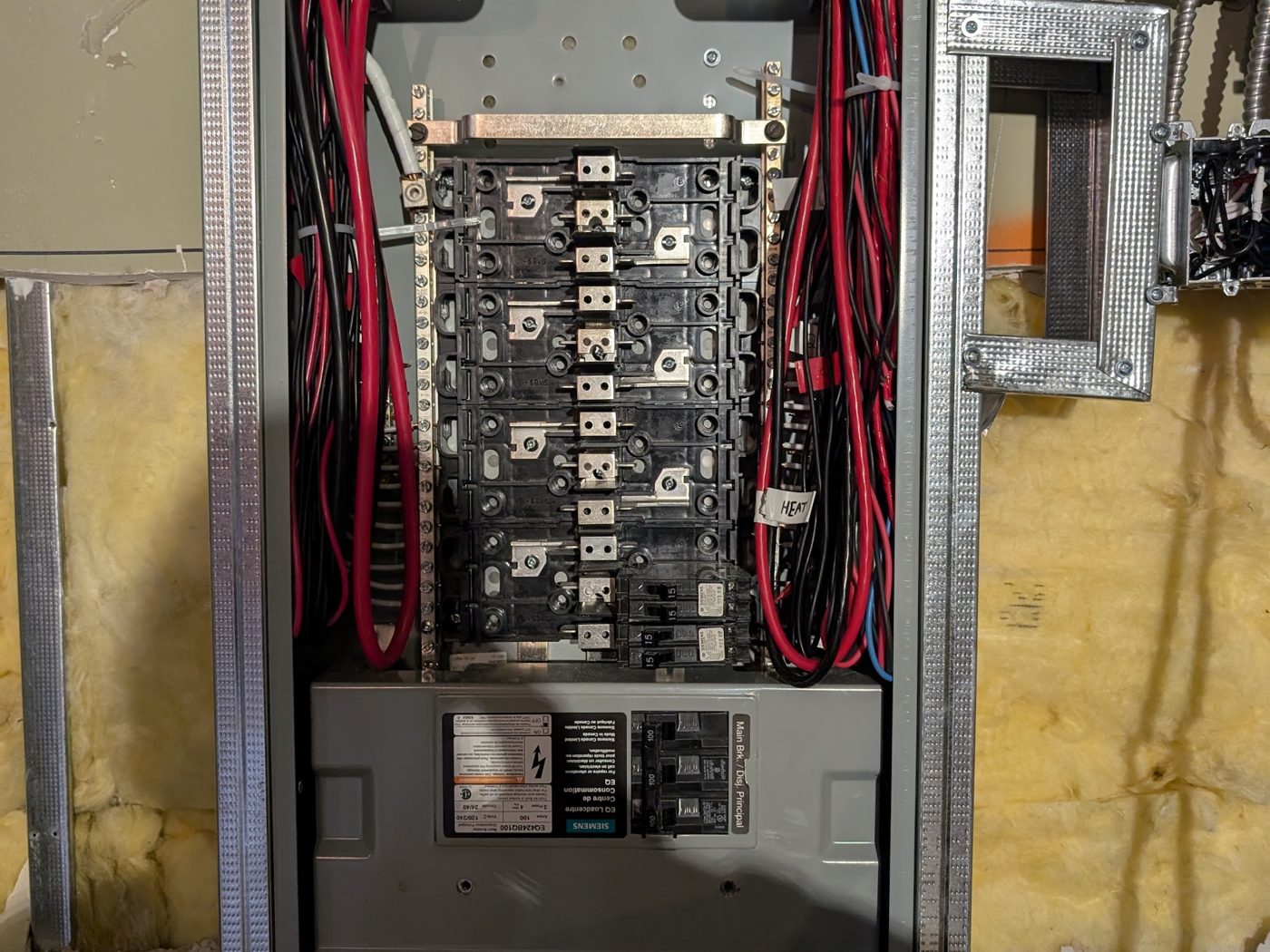 Electrician wiring breakers, a key factor in electrical panel replacement cost in Vancouver