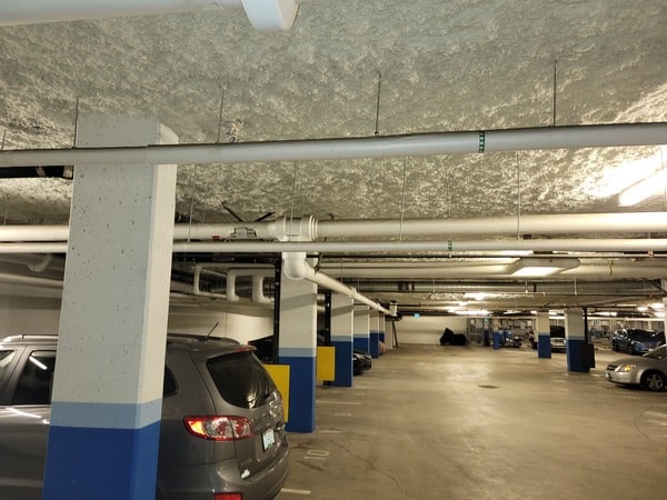 Cars parked in an underground parking lot at a strata property for EV Installation by TCA Electric