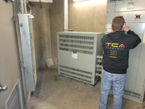 TCA Electric technician installing EV charging equipment as part of the BC Hydro EV Ready Plan