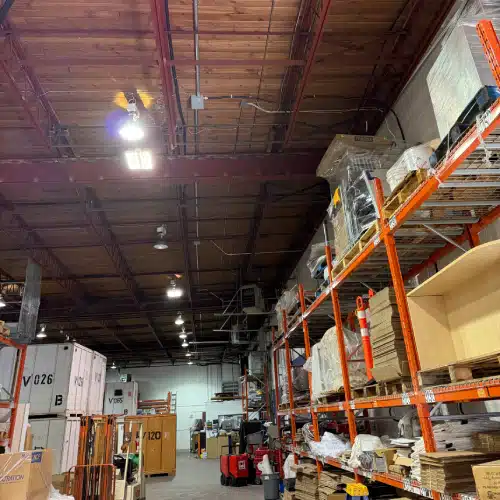 Interior of industrial warehouse with open floor space and lighting for commercial EV charging solutions by TCA Electric