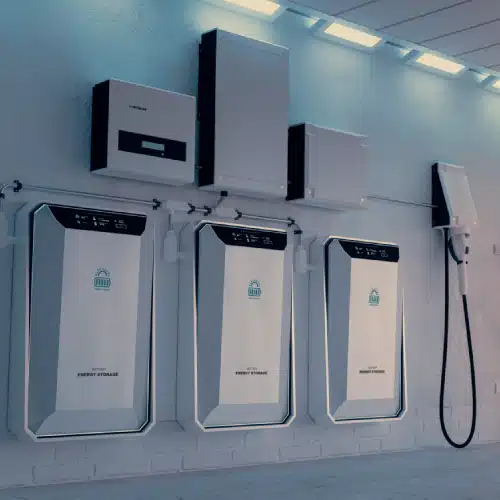 Sigenergy home energy management system featuring wall-mounted battery storage units, inverter, control modules, and electric vehicle charging station in a well-lit garage