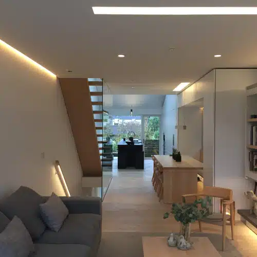 Modern open-plan living and dining area in a smart home powered by a Sigenergy home energy management system, with large windows and natural lighting