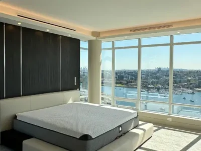 LED lighting upgrade highlighting a modern bedroom with floor-to-ceiling windows overlooking the city by TCA Electric in Canada