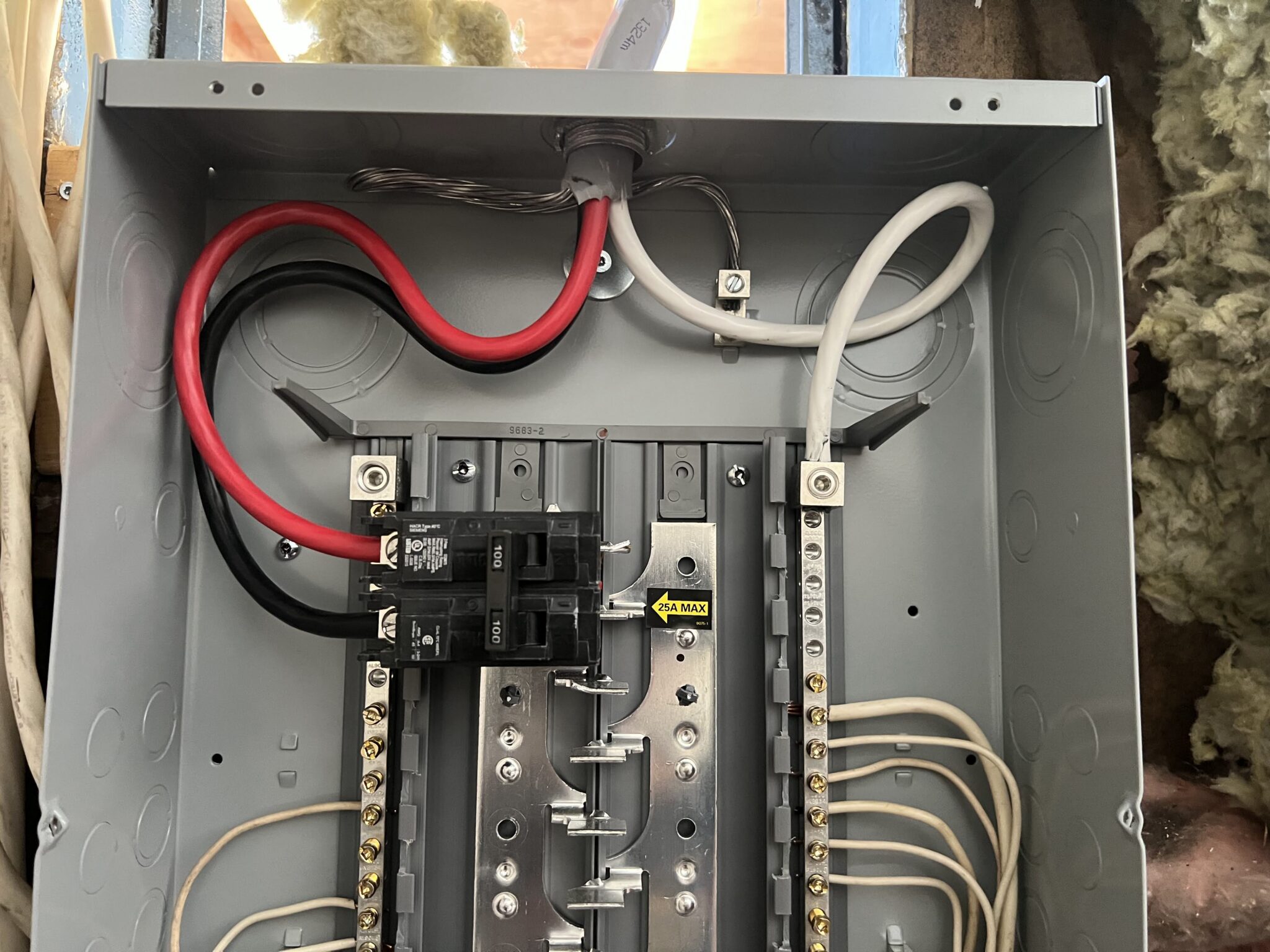 Interior view of an open breaker panel box showing thick red, black, and neutral service cables explaining what is involved in upgrading to 200 amp service in North Vancouver by TCA Electric.